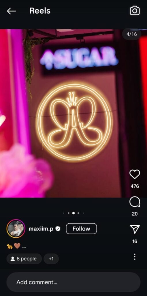 Maxiim at the ABH Twin Flame Party wearing glam makeup, posing at a branded event backdrop with Sugar & Spice campaign elements