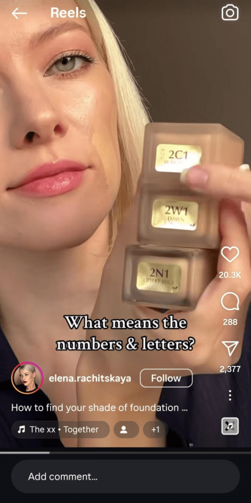 A woman holding a stack of foundation shades with labels, showing a makeup tutorial on choosing the right shade.